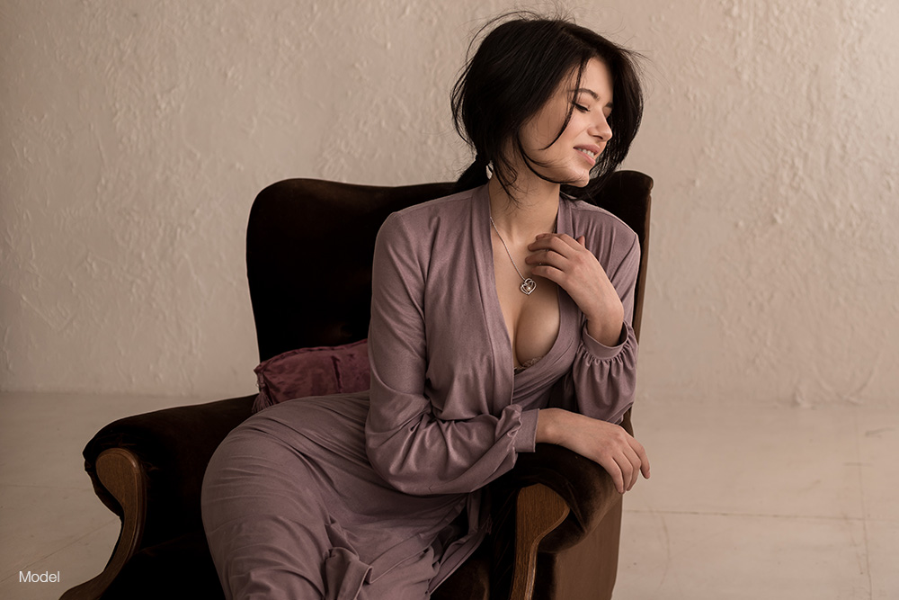 Woman in a dress sitting on a chair